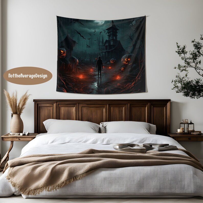 May include: A dark, spooky Halloween tapestry featuring a haunted house with glowing jack-o'-lanterns and a lone figure walking towards it. The tapestry is hanging on a white wall above a wooden bed with a white duvet and a brown throw blanket.