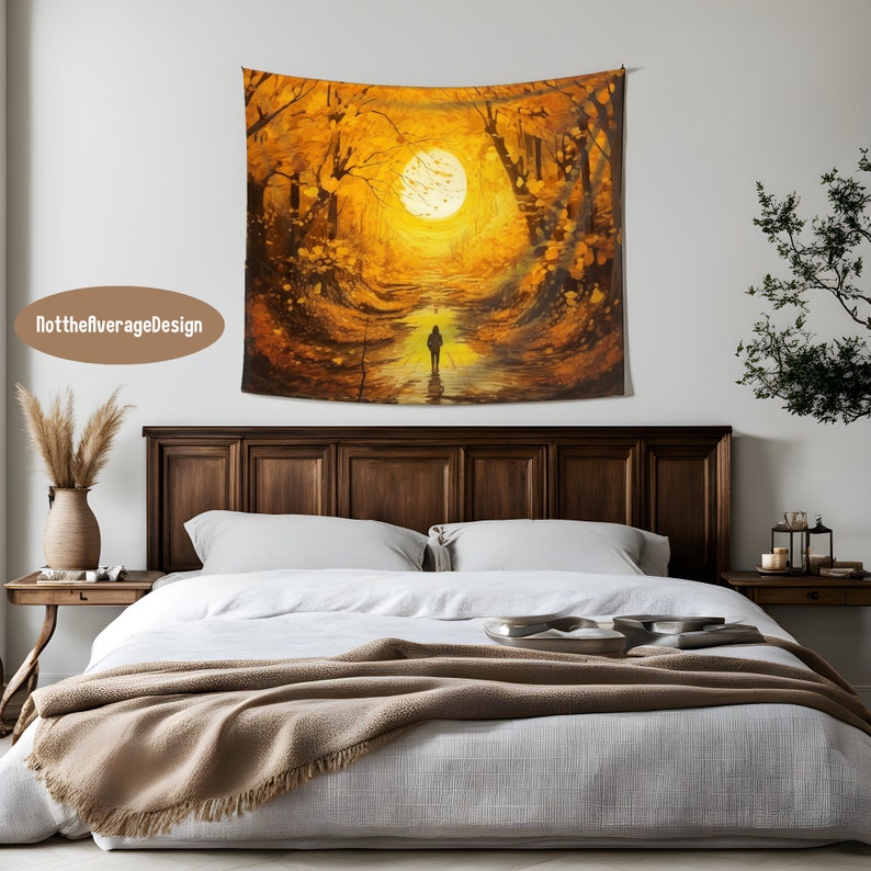 May include: A tapestry featuring a painting of a forest path with golden leaves and a single figure walking towards a bright sun in the distance.
