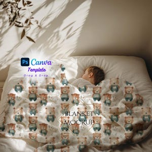 May include: A white blanket featuring a repeating pattern of watercolour teddy bears in brown and blue. The blanket covers a bed with a sleeping child. The image includes the text "Ps Canva Template Drag & Drop" and "BLANKET MOCKUP".