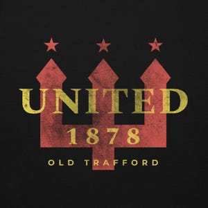 May include: A distressed graphic on a black background features the word "UNITED" in yellow, above the number "1878" and the words "OLD TRAFFORD". The design includes a red trident shape with three stars at the top.