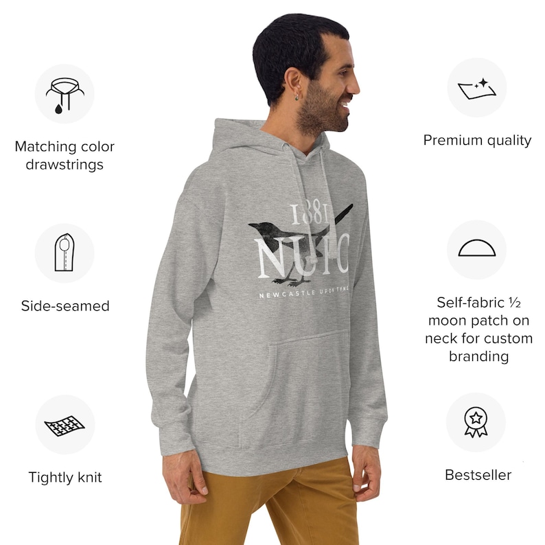 May include: A light gray hoodie with a front pocket and a drawstring hood. The hoodie features a black and white graphic of a bird and the text "1881 NUIC Newcastle Outfitters". The hoodie is side-seamed and tightly knit.