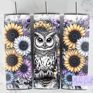 May include: Three stainless steel tumblers with a white background and a design of sunflowers, purple flowers, and an owl. The owl is black and white and has a detailed design. The tumblers are perfect for everyday use.
