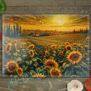 May include: A glass cutting board with a colorful sunset scene over a field of sunflowers. The scene is painted in a stylized, almost abstract style. The cutting board is rectangular and has a smooth, glossy surface.