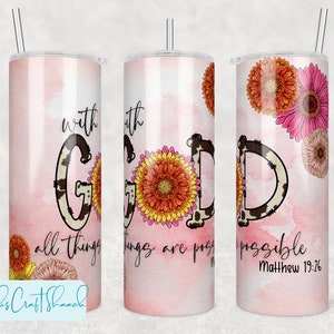 May include: A pink and white tumbler with a cow print design and the text "with God all things are possible Matthew 19:26". The tumbler is decorated with orange, yellow, and pink flowers.