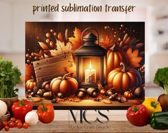 May include: A printed sublimation transfer featuring a fall harvest scene. The image includes pumpkins, acorns, and autumn leaves. A lit lantern with a candle sits in the center. The text "printed sublimation transfer" is at the top.