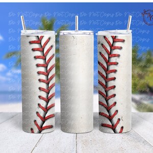 May include: Three stainless steel tumblers with a baseball stitch design. The tumblers are white with red stitching. The tumblers are on a wooden surface.