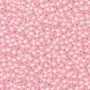 May include: A pink fabric with a white floral pattern. The fabric is covered in tiny white flowers with a light pink background.