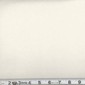 May include: Off-white fabric with a textured surface. A metal ruler with inch markings is at the bottom, measuring up to 11 inches. The fabric is a solid color and appears to be a textile.