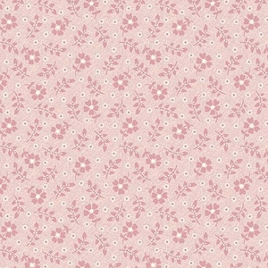 May include: A pink fabric with a repeating pattern of small white flowers and pink leaves. The fabric is a light pink color and has a subtle texture.