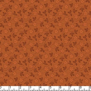 May include: A brown fabric with a repeating pattern of small orange flowers and dark brown leaves. The fabric has a textured surface.