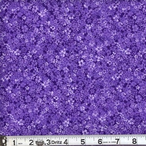 May include: Purple fabric with a small white floral pattern. The fabric is measured with a ruler in inches.