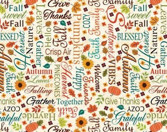 May include: A cream-colored fabric with a repeating pattern of autumn-themed words, pumpkins, sunflowers, and leaves in various colors. The words include "Harvest," "Grateful," and "Fall."