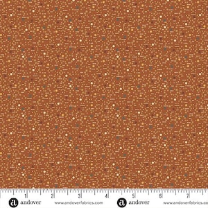May include: A fabric with a repeating pattern of small, colorful dots in shades of brown, tan, and blue on a rust-colored background. The fabric has a textured appearance and is suitable for various sewing projects.