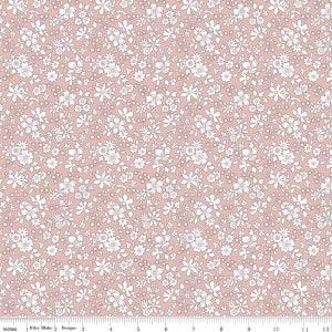 May include: A pink fabric with a white floral pattern. The fabric is covered in small white flowers and leaves.