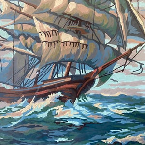 May include: A painting of a large sailing ship with white sails, a brown hull, and a blue and green ocean. The ship is sailing through choppy waves.