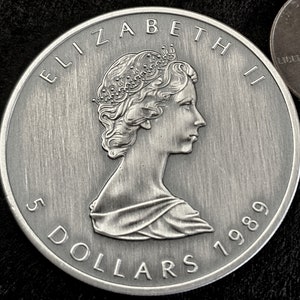 The 1989 &#39;Canadian Silver Maple Leaf&#39; 1 Troy Ounce of .9999 Antiqued Silver Coin