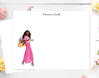 May include: A white card with a black and white illustration of a woman in a pink dress carrying a basket of flowers. The text "Veronica Smith" is printed at the top of the card.