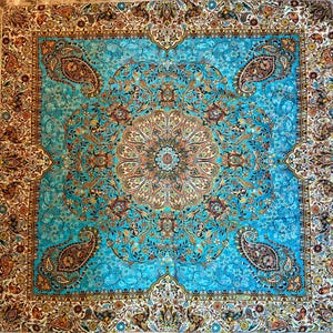 May include: A blue and gold patterned rug with a central medallion design. The rug has a traditional Persian style with intricate floral and paisley motifs.