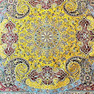May include: A yellow, red, and blue patterned rug with a central medallion and paisley designs.