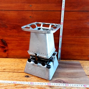 Vintage open fire cooking stove with three burners running on kerosene. An old tourist or village stove running on kerosene.