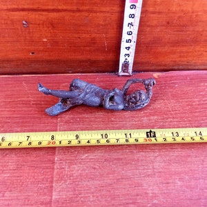 Part of an ancient bronze sculpture or part of a dish. Historical artifact. Ancient bronze detail.