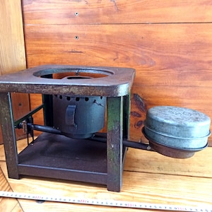 Vintage open fire cooking stove with one burner running on kerosene. An old tourist or village stove that runs on kerosene. An antique gift.