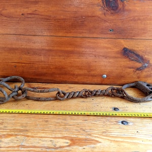 Antique forged shackles of the 18th centuries. Horse leg shackles. Prison shackles on the legs. Prison handcuffs. Handcuffs.