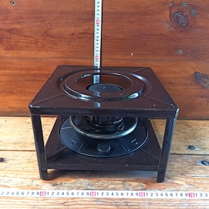Vintage open fire cooking stove with one burner running on kerosene. An old tourist or village stove that runs on kerosene. An antique gift.