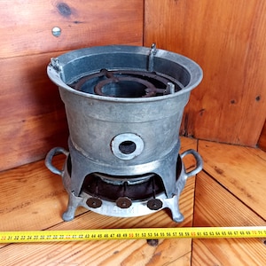 An old kerosene stove for cooking over an open fire from the 60-70s of the 20th century. Historical artifact. Antique gift.