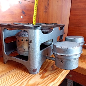 An old two-burner kerosene stove for cooking over an open fire. 50-60s sample Historical artifact Antique gift