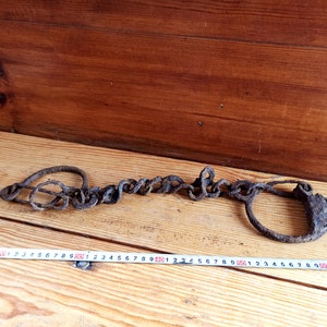 Antique forged shackles of the 18th-19th centuries. Horse leg shackles. Prison shackles on the legs. Prison handcuffs. Handcuffs.