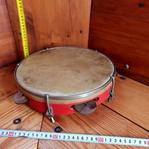 Vintage percussion musical instrument - tambourine. Ritual instrument. Music of shamans. Percussion instrument.