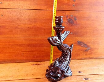 Antique ceramic candlestick in the shape of a fantastic fish-like creature. Antique souvenir. Halloween gift. Antique gift.