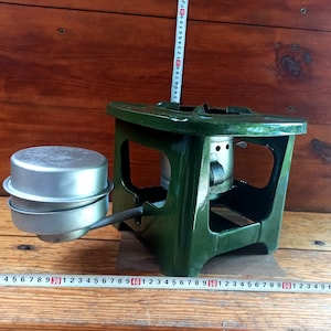 Vintage open fire cooking stove with one burner running on kerosene. An old tourist or village stove that runs on kerosene. An antique gift.
