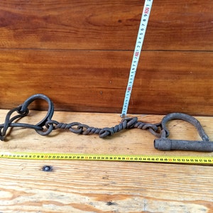 Vintage forged shackles of the 18th-19th centuries. Horse leg shackles. Prison shackles on the legs. Prison handcuffs. Handcuffs.