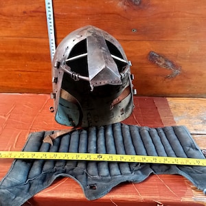 Author&#39;s copy of a medieval warrior&#39;s combat helmet for sports tournaments. Combat helmet for interior decoration. Helmet.