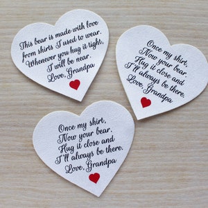 May include: Three heart-shaped cards with handwritten messages and a red heart. The messages are from Grandpa, expressing love and comfort. The cards are white with black text, and are on a light wood surface.
