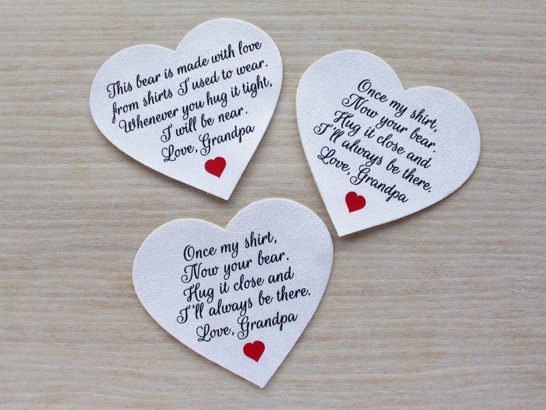 May include: Three heart-shaped cards with handwritten messages and a red heart. The messages are from Grandpa, expressing love and comfort. The cards are white with black text, and are on a light wood surface.