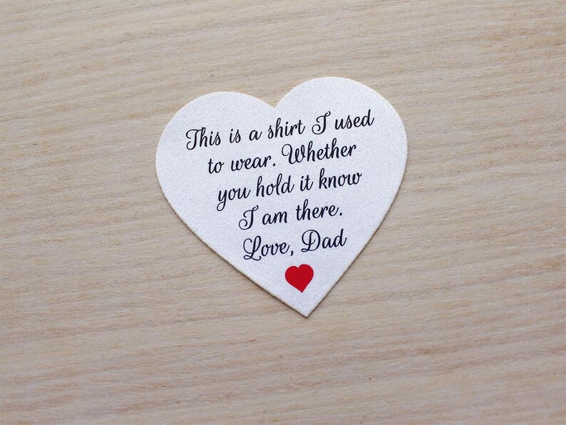 May include: A heart-shaped white fabric patch with black script that reads "This is a shirt I used to wear. Whether you hold it know I am there. Love, Dad." A small red heart is at the bottom.