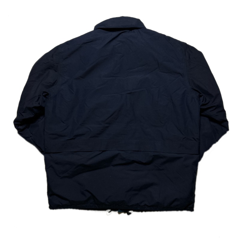 May include: A dark blue jacket with a zipper closure and a drawstring at the bottom.