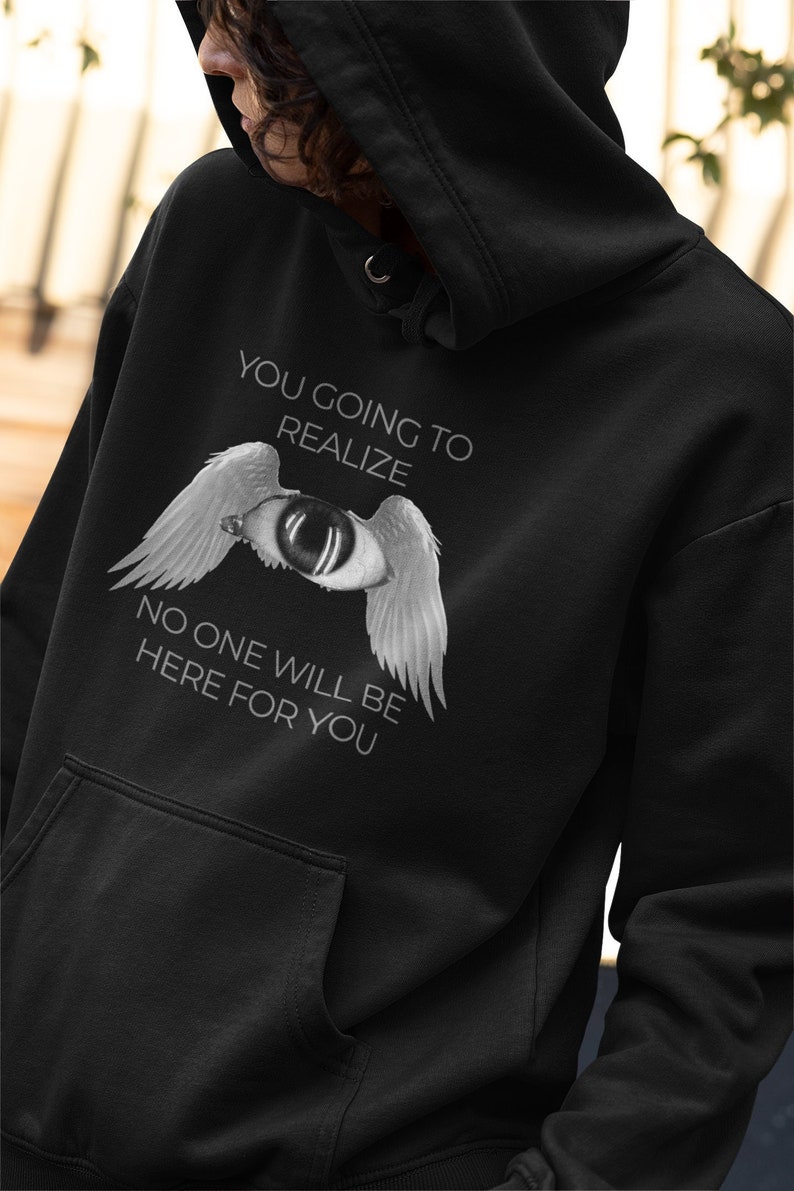 May include: Black hooded sweatshirt with a white graphic print of an eye with wings. The text "You going to realize no one will be here for you" is printed below the graphic.