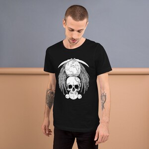 May include: Black t-shirt with a white graphic of a skull with wings and a globe on top. The globe is surrounded by a crescent moon.