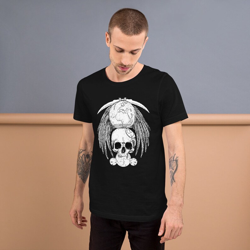 May include: Black t-shirt with a white graphic of a skull with wings and a globe on top. The globe is surrounded by a crescent moon.