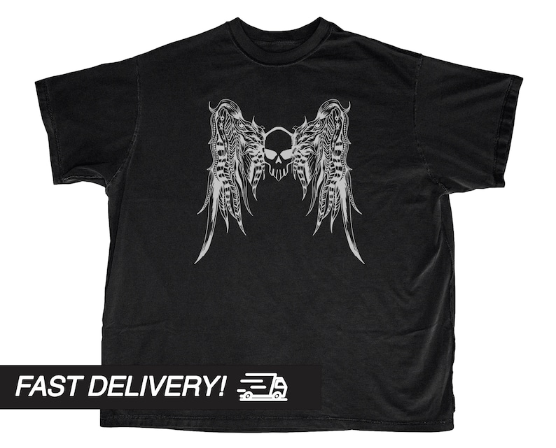 May include: Black t-shirt featuring a detailed white graphic of a skull with feathered wings. The design is centered on the shirt. The shirt has a classic crew neck and short sleeves. The text "FAST DELIVERY!" is at the bottom.