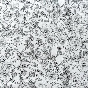 May include: Close-up of white fabric with a black floral pattern. The design features stylized flowers, leaves, and vines, creating a detailed botanical print. The pattern is evenly distributed across the fabric, ideal for textiles.