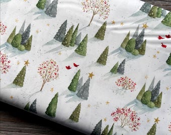May include: White fabric with a winter scene featuring green and gray trees, red birds, and gold stars. The fabric has a watercolor style with a snowy landscape design. The trees are various sizes and shapes, creating a whimsical forest.