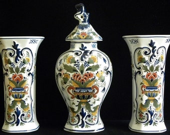 Royal Delft polychrome (1976/ 1977) handpainted three-piece kaststel: two beaker vases and covered pul (Porceleyne Fles)