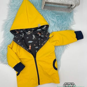 May include: A yellow hooded jacket with a black and white patterned lining. The jacket has a zipper closure and navy blue trim on the cuffs and pockets.