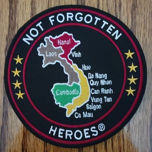 May include: A black embroidered patch with a red border and white text that reads "NOT FORGOTTEN HEROES®". The patch features a map of Vietnam with the names of cities and regions, including Hanoi, Laos, Vinh, Hue, Da Nang, Quy Nhon, Cambodia, Can Ranh, Vung Tan, Saigon, and Ca Mau.