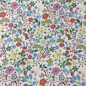 May include: White fabric with a repeating pattern of small, colourful flowers and leaves. The flowers are in shades of pink, blue, yellow, and red.